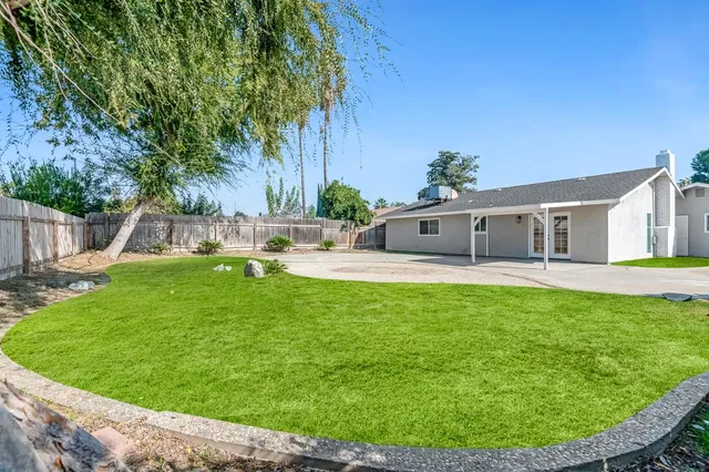 a view of a house with a backyard porch and sitting area