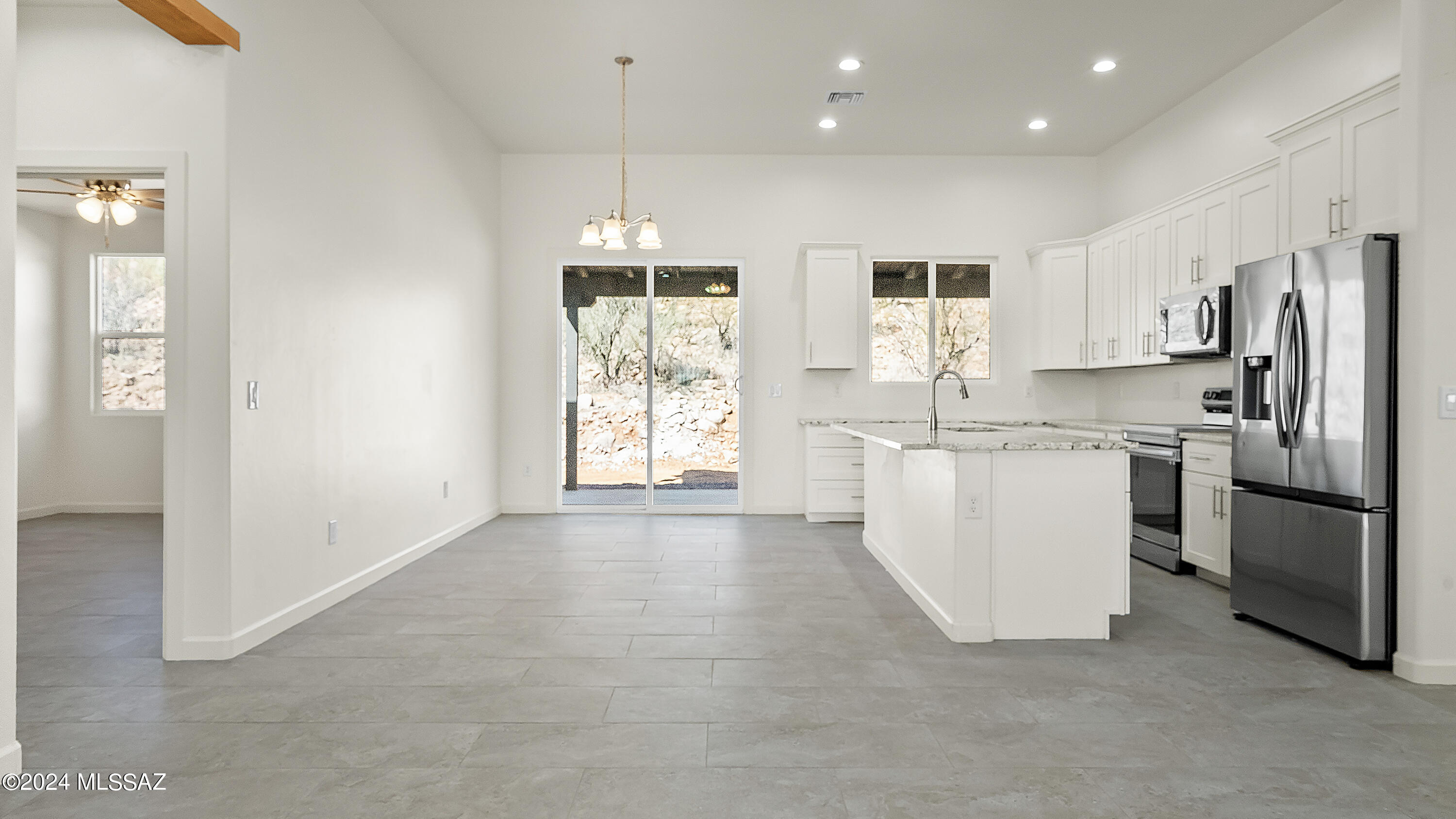 1817 Vereda Iberia Rio Rico, AZ 85648 - Photo 8 of 25 a kitchen with white cabinets and stainless steel appliances