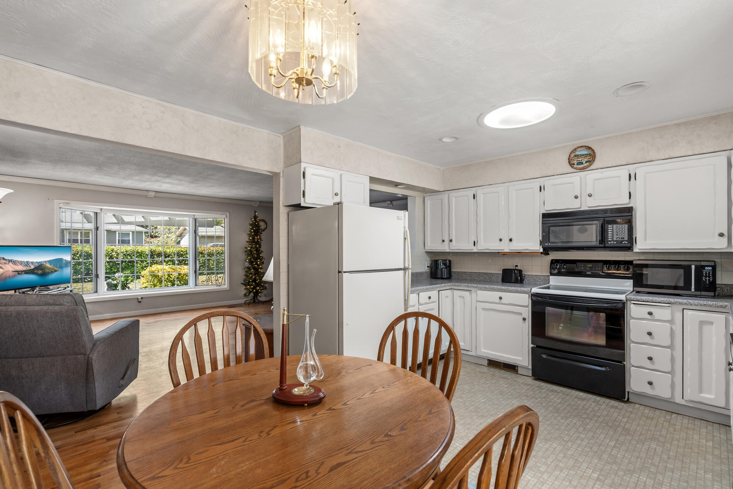 110 North 2nd Street Talent, OR 97540 - Photo 27 of 27 a kitchen with stainless steel appliances granite countertop a stove a refrigerator a dining table and chairs