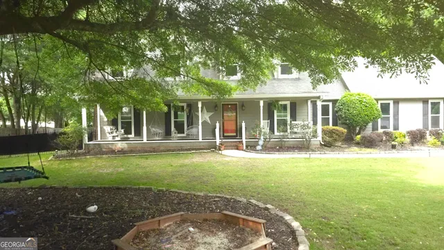 a view of a house with backyard porch and sitting area