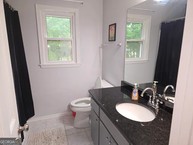a view of a livingroom with wooden floor and a fireplace