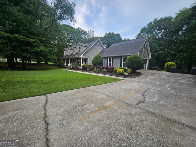 a front view of a house with garden