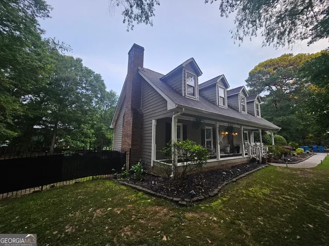 a front view of house with yard and green space