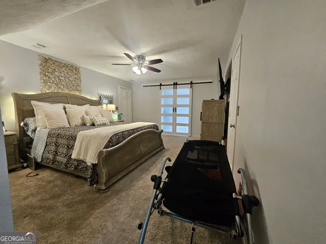 a bathroom with a granite countertop sink a toilet a mirror a vanity and shower