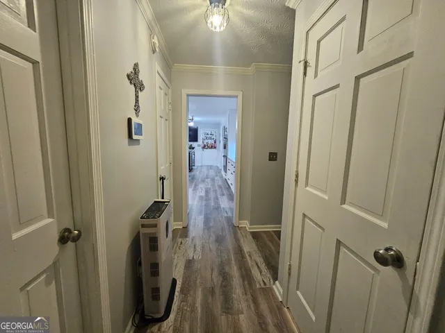 a kitchen with stainless steel appliances granite countertop a lot of counter space and wooden floors