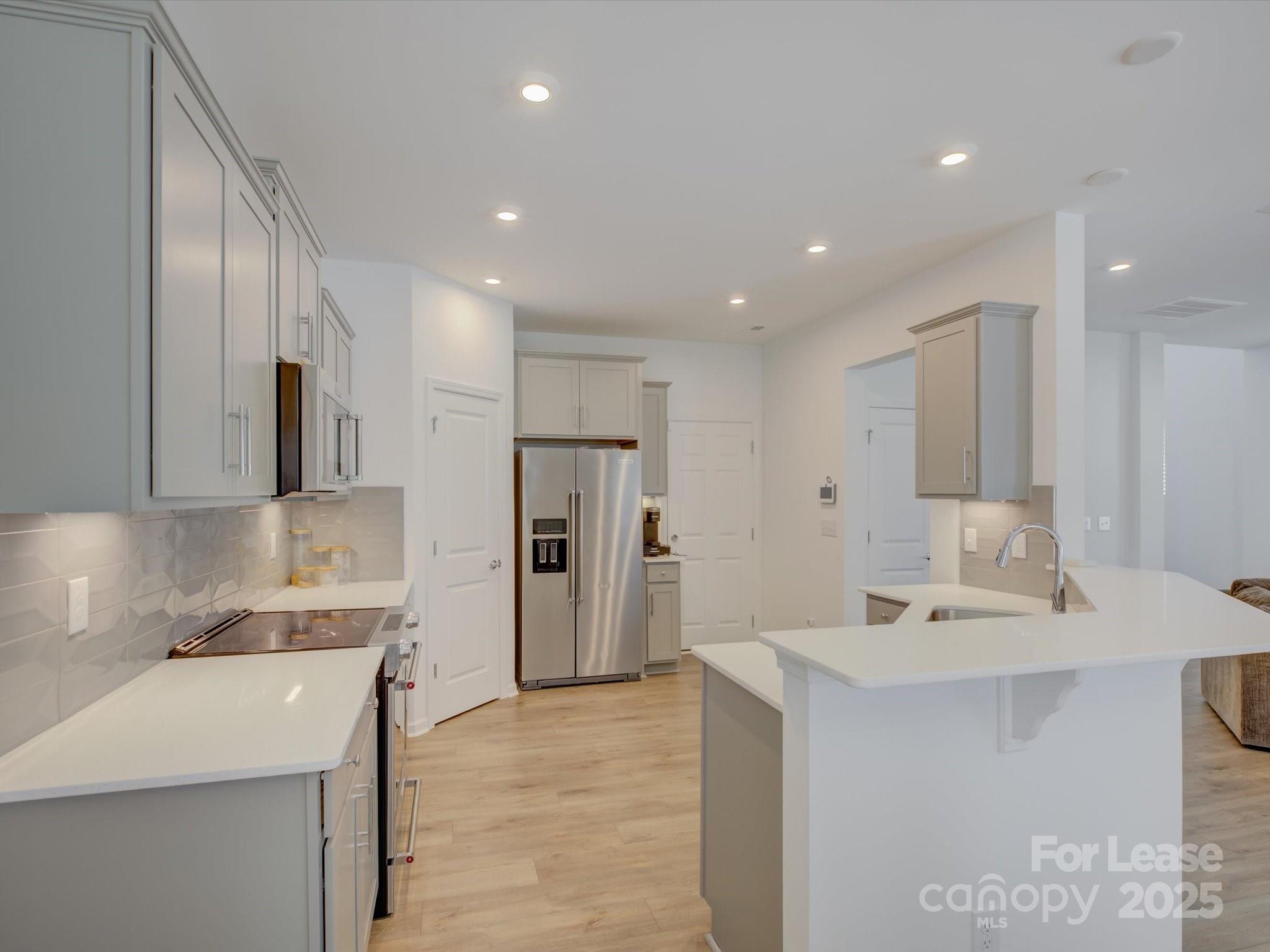 13124 Rover Street Charlotte, NC 28273 - Photo 11 of 46 a bathroom with a sink a mirror and a shower