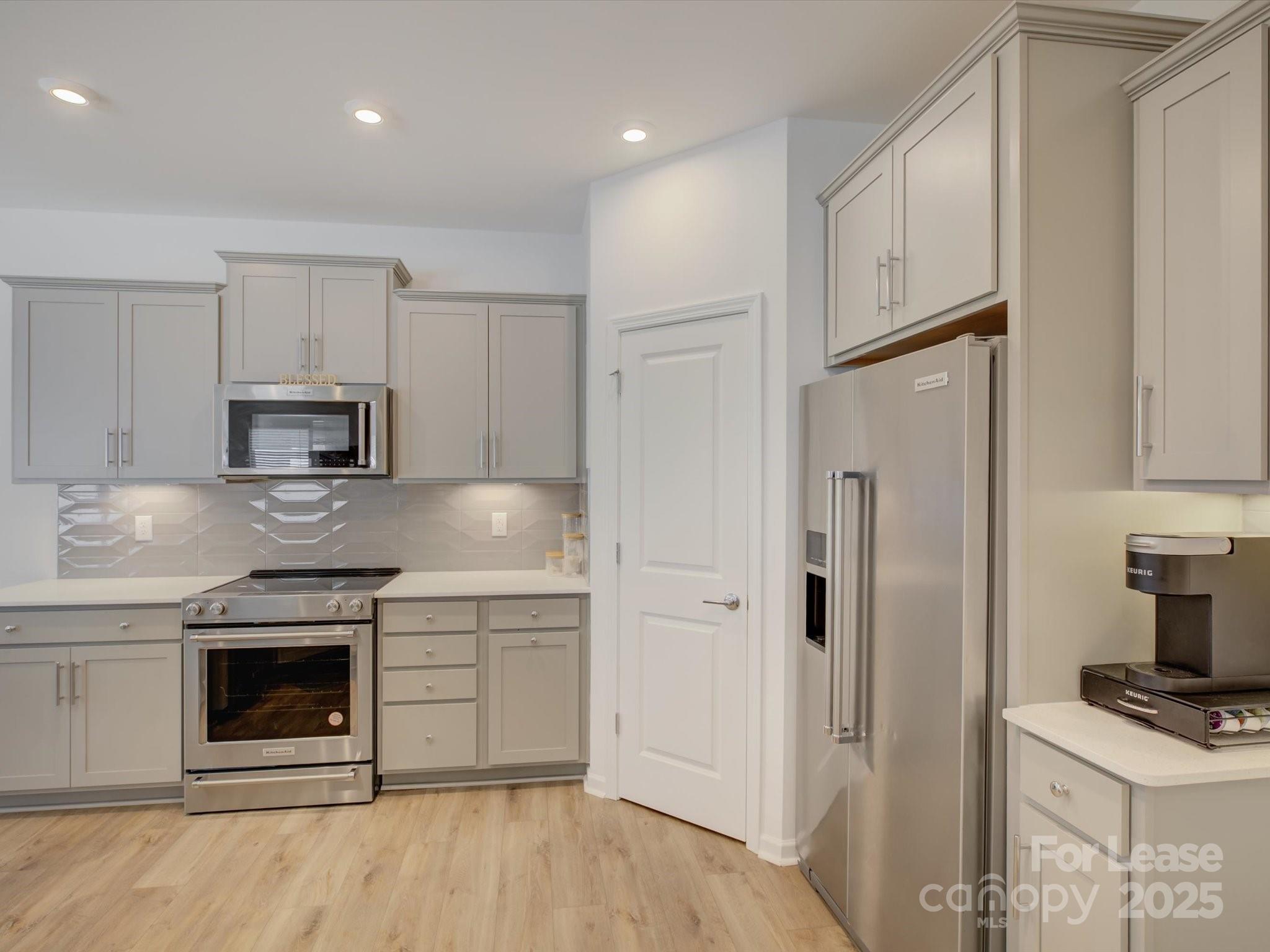 13124 Rover Street Charlotte, NC 28273 - Photo 13 of 46 a kitchen with stainless steel appliances granite countertop a stove a refrigerator and a sink
