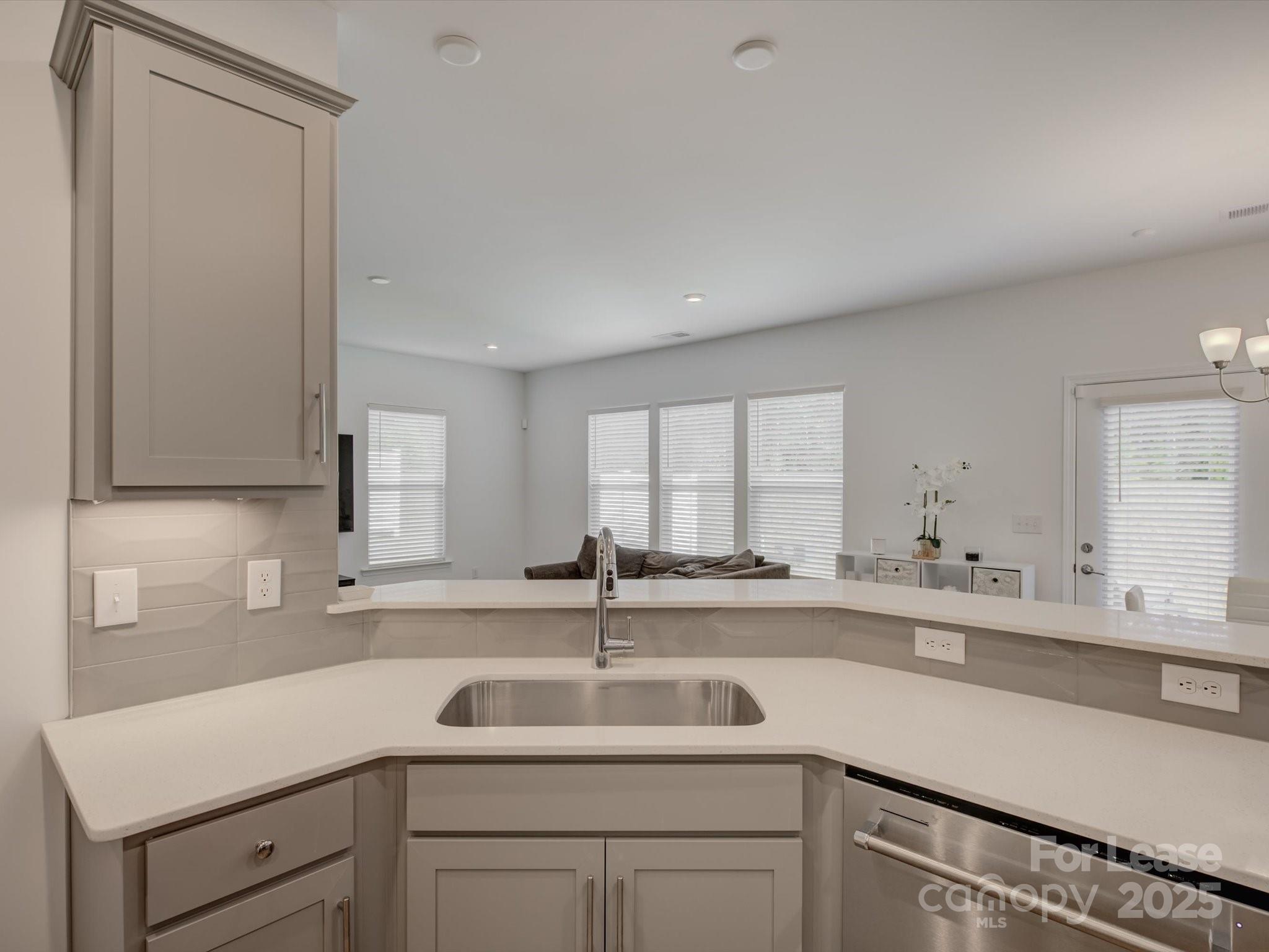 13124 Rover Street Charlotte, NC 28273 - Photo 15 of 46 a kitchen with a sink and cabinets