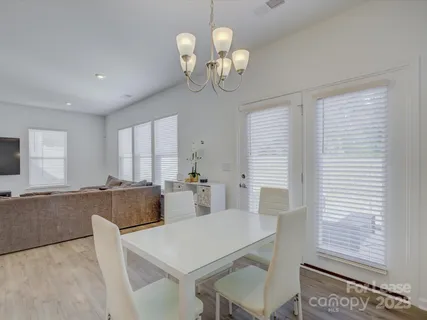 a view of a dining room with furniture and chandelier