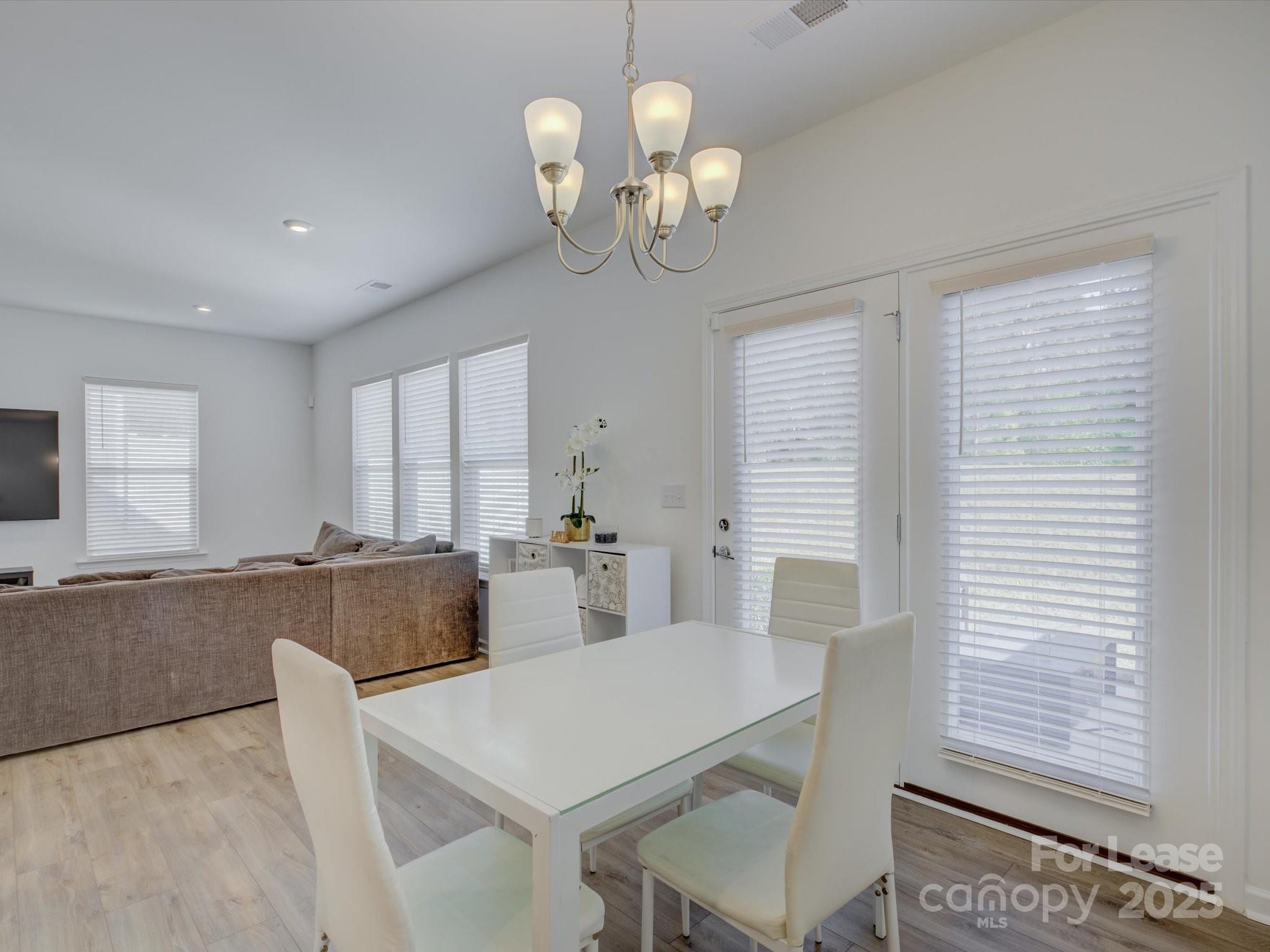13124 Rover Street Charlotte, NC 28273 - Photo 16 of 46 a view of a dining room with furniture and chandelier