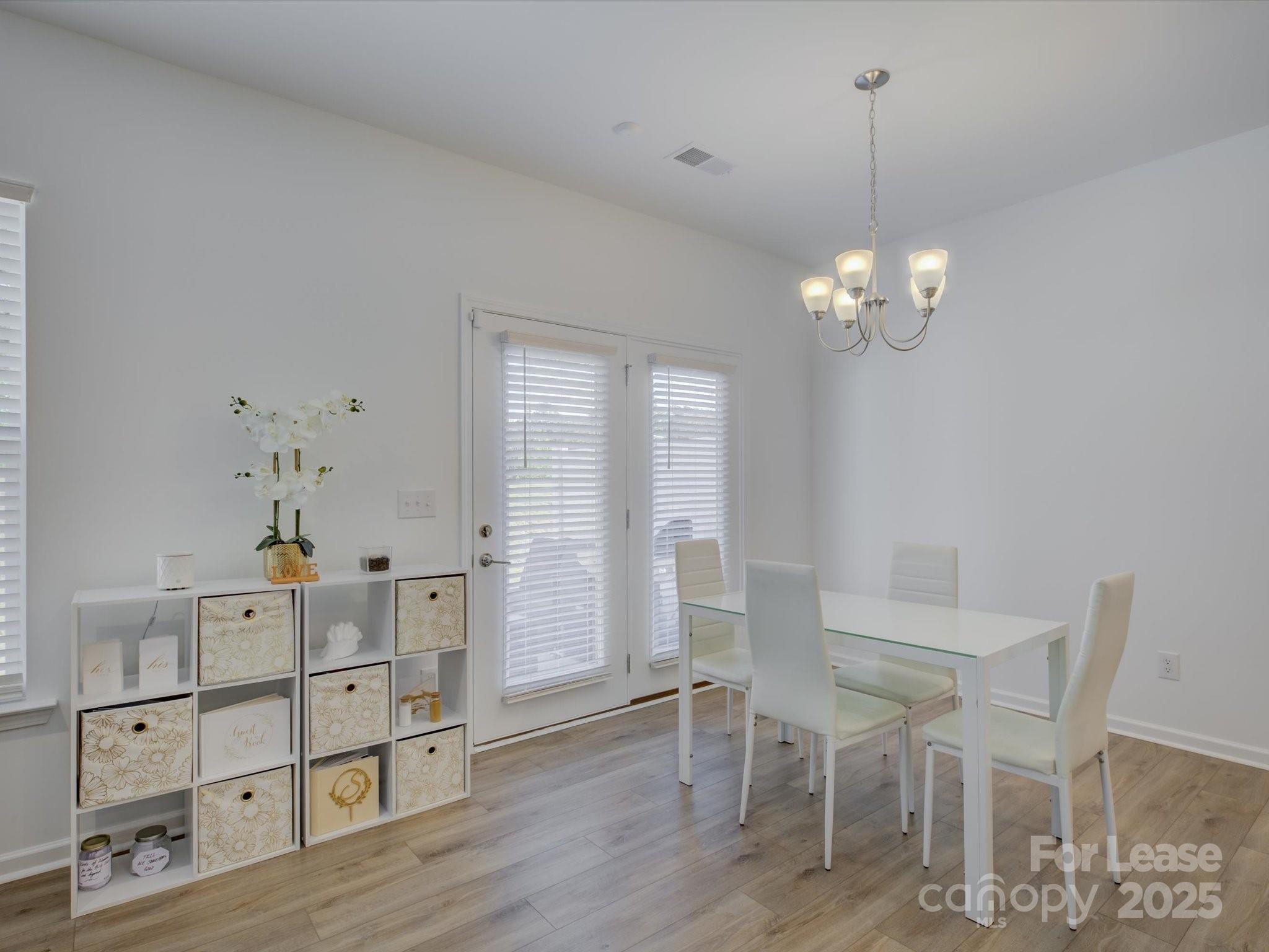 13124 Rover Street Charlotte, NC 28273 - Photo 18 of 46 a view of a dining room with furniture and wooden floor