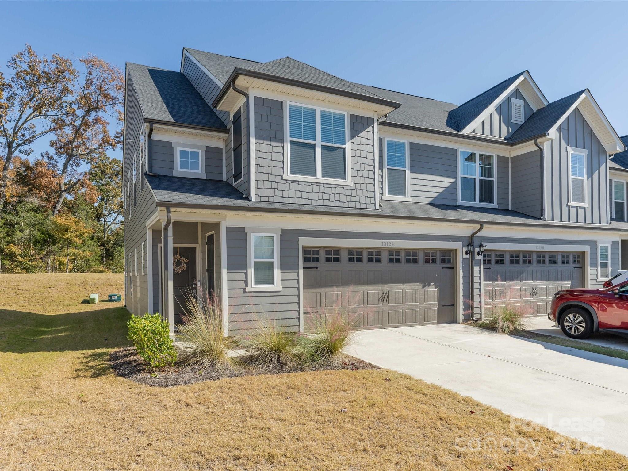 13124 Rover Street Charlotte, NC 28273 - Photo 2 of 46 a front view of a house with a yard