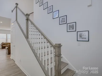 a view of entryway and hall with wooden floor