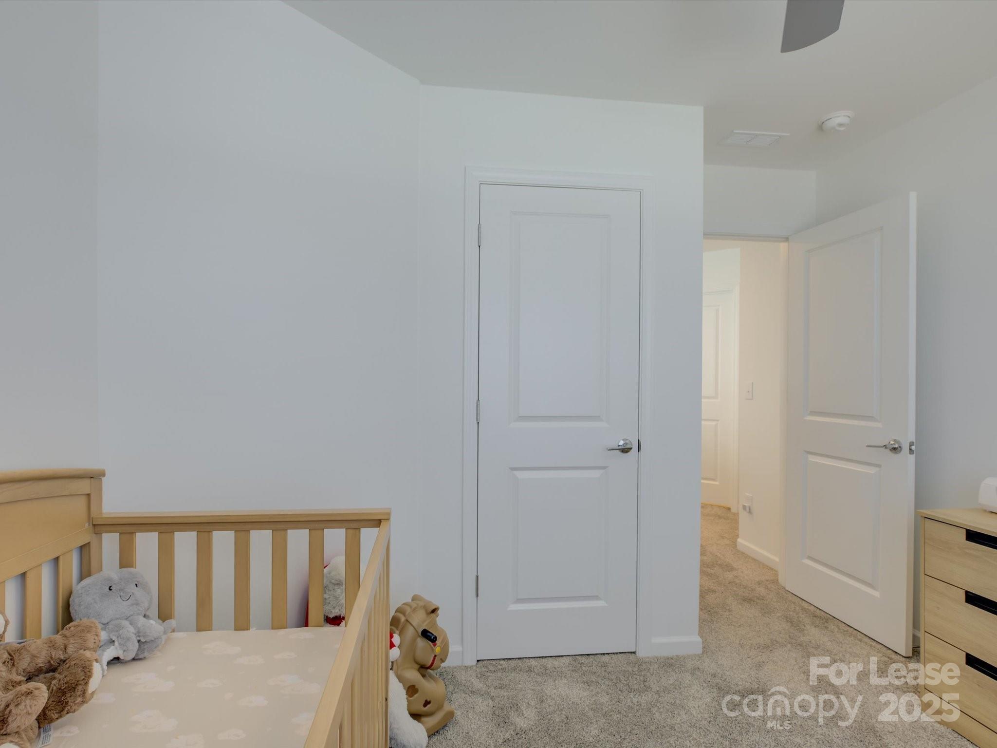 13124 Rover Street Charlotte, NC 28273 - Photo 25 of 46 a bedroom with a bed and closet