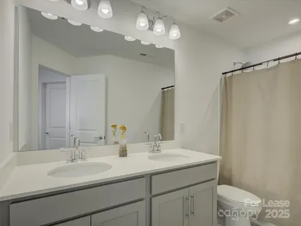 a bathroom with a sink double vanity and a mirror