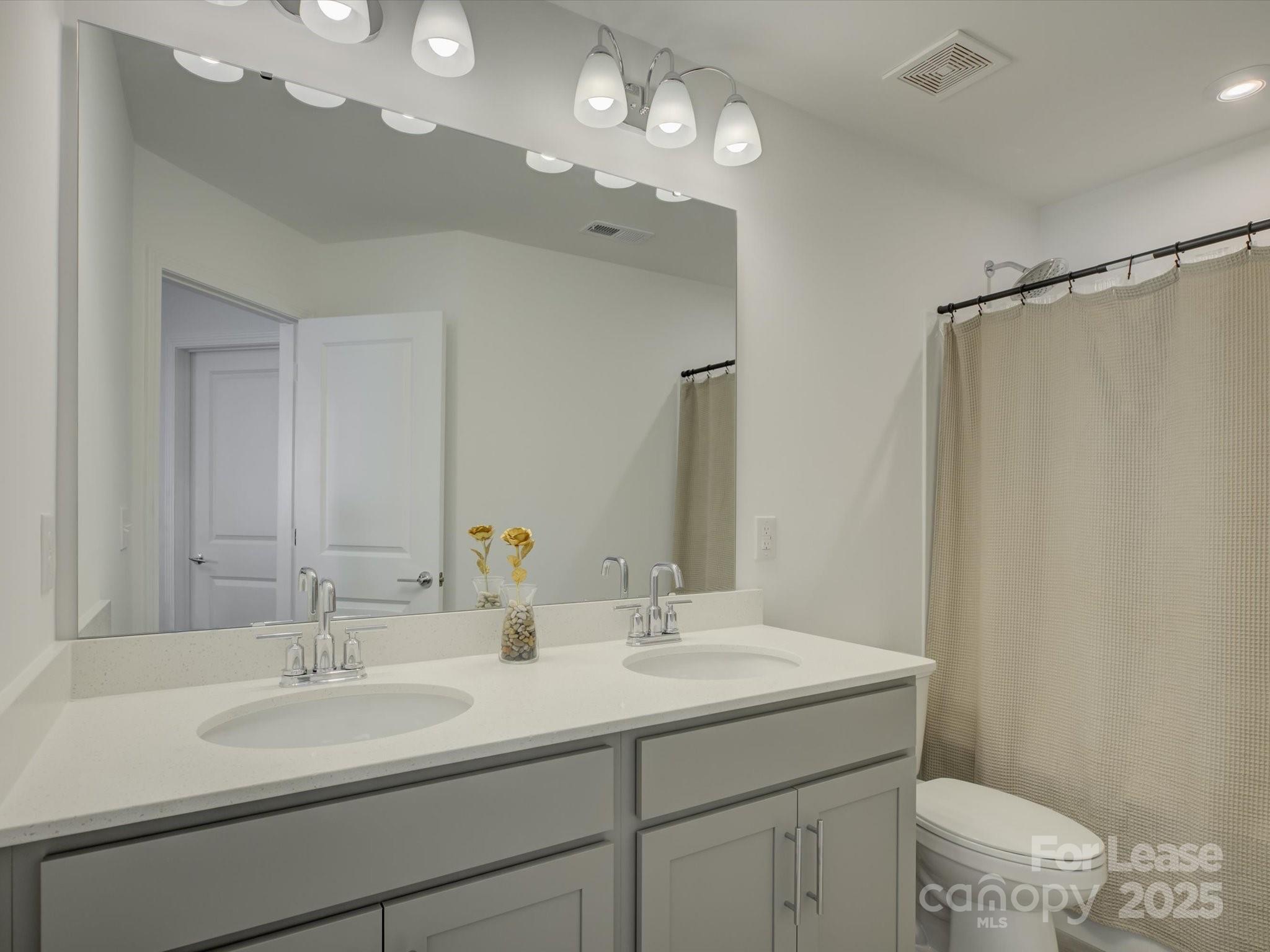 13124 Rover Street Charlotte, NC 28273 - Photo 26 of 46 a bathroom with a sink double vanity and a mirror