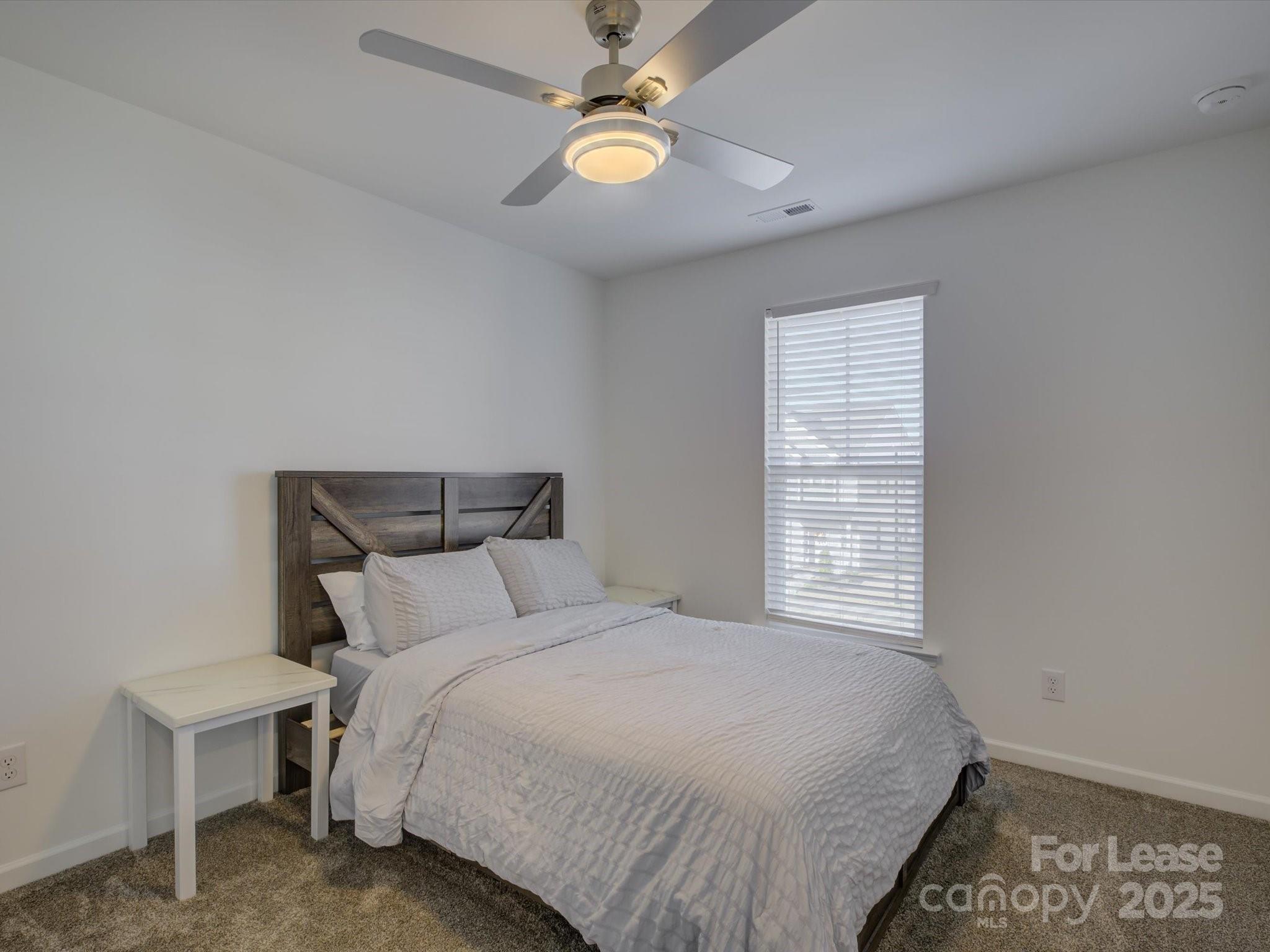 13124 Rover Street Charlotte, NC 28273 - Photo 27 of 46 a bedroom with a bed and a window