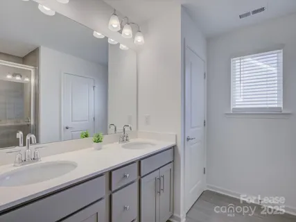 a bathroom with a sink double vanity and a mirror