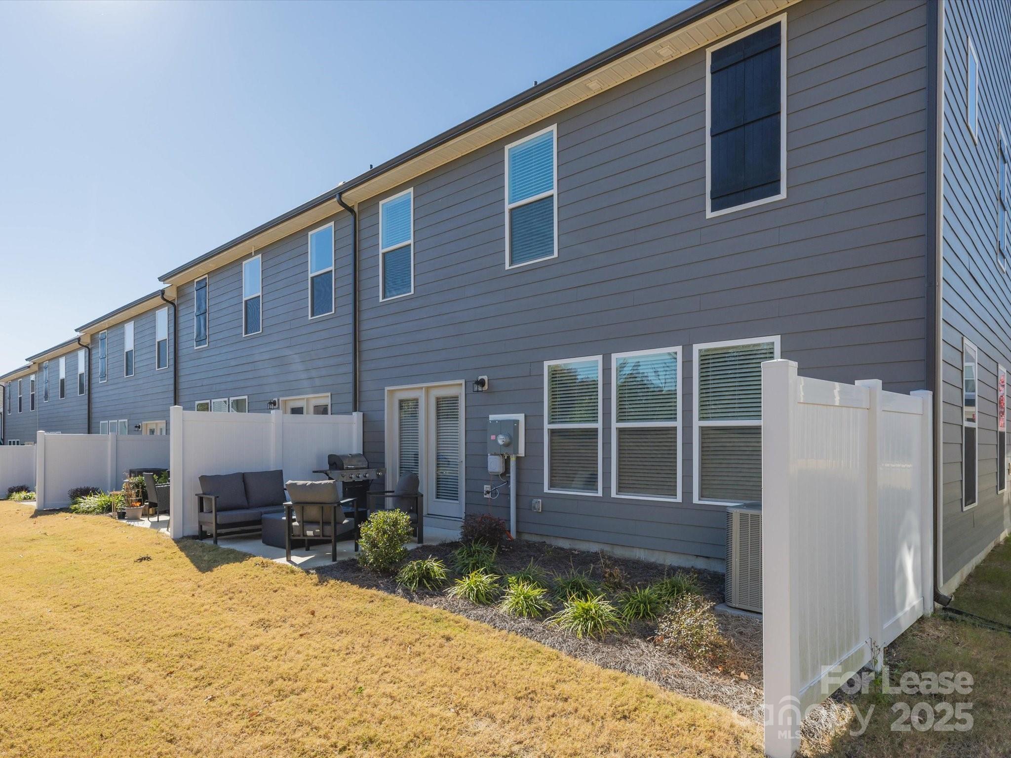 13124 Rover Street Charlotte, NC 28273 - Photo 39 of 46 a front view of a house with a yard