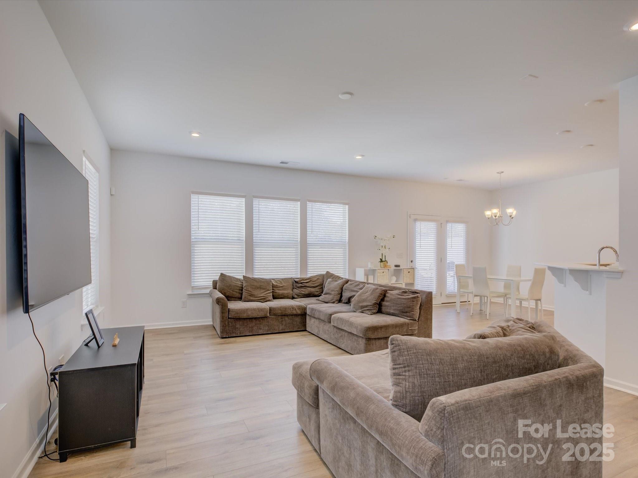 13124 Rover Street Charlotte, NC 28273 - Photo 7 of 46 a living room with furniture and a flat screen tv