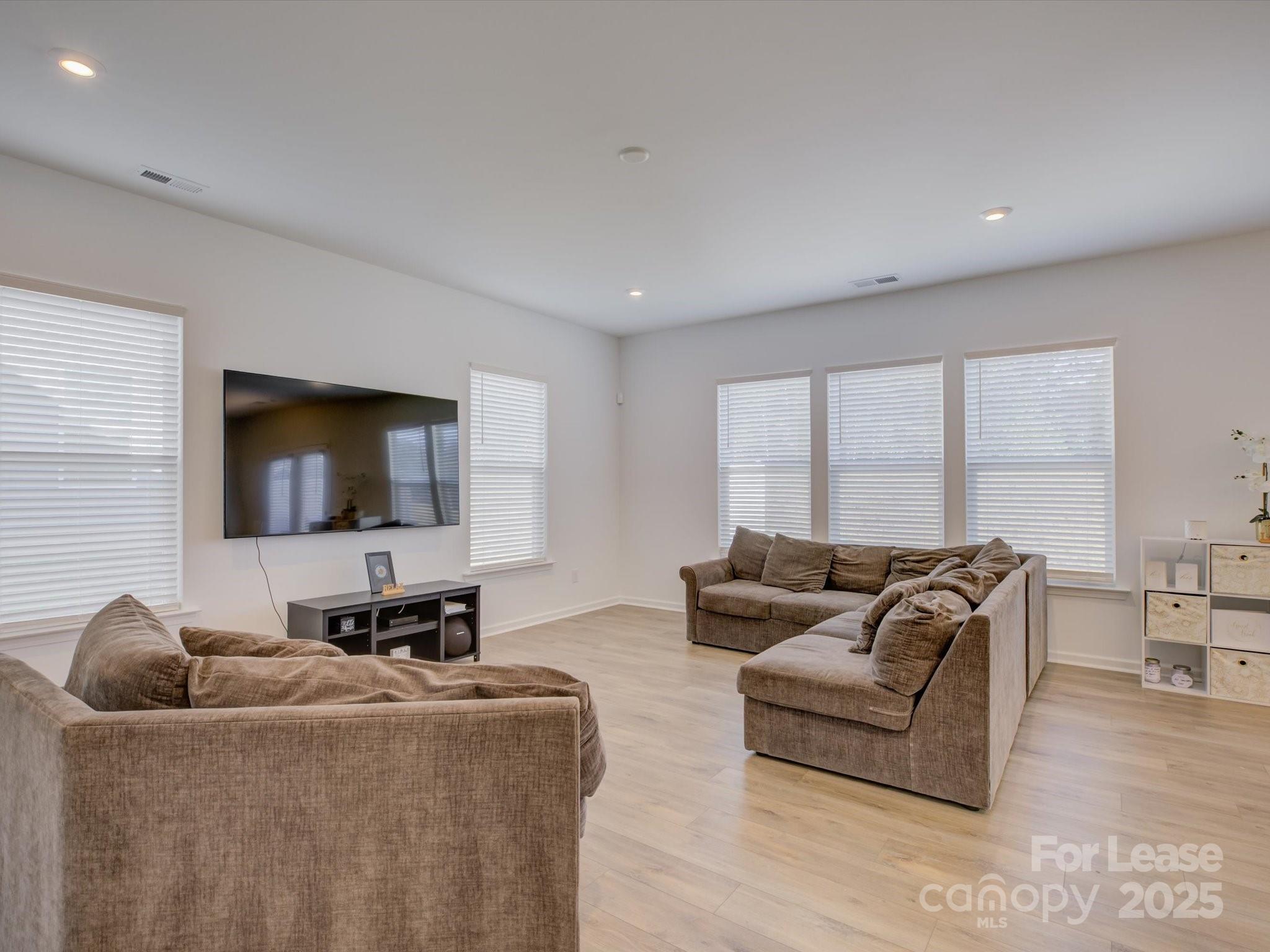 13124 Rover Street Charlotte, NC 28273 - Photo 8 of 46 a living room with furniture and a flat screen tv