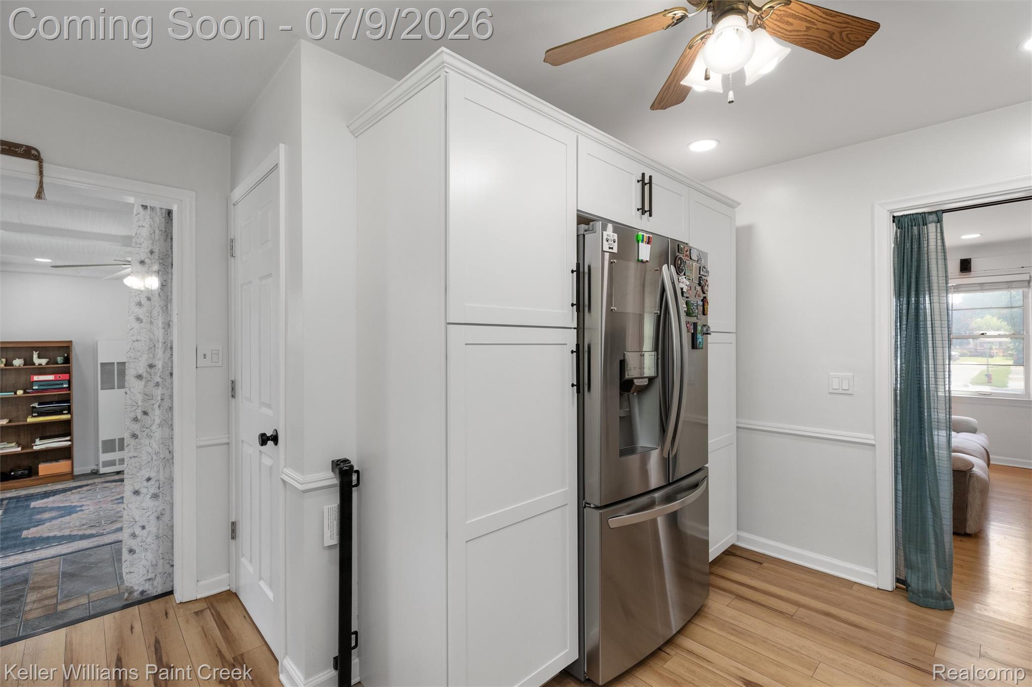 2731 Crooks Road Royal Oak, MI 48073 - Photo 14 of 34 Stainless steel refrigerator integrated into custom white cabinetry, featuring crown molding and matte black hardware