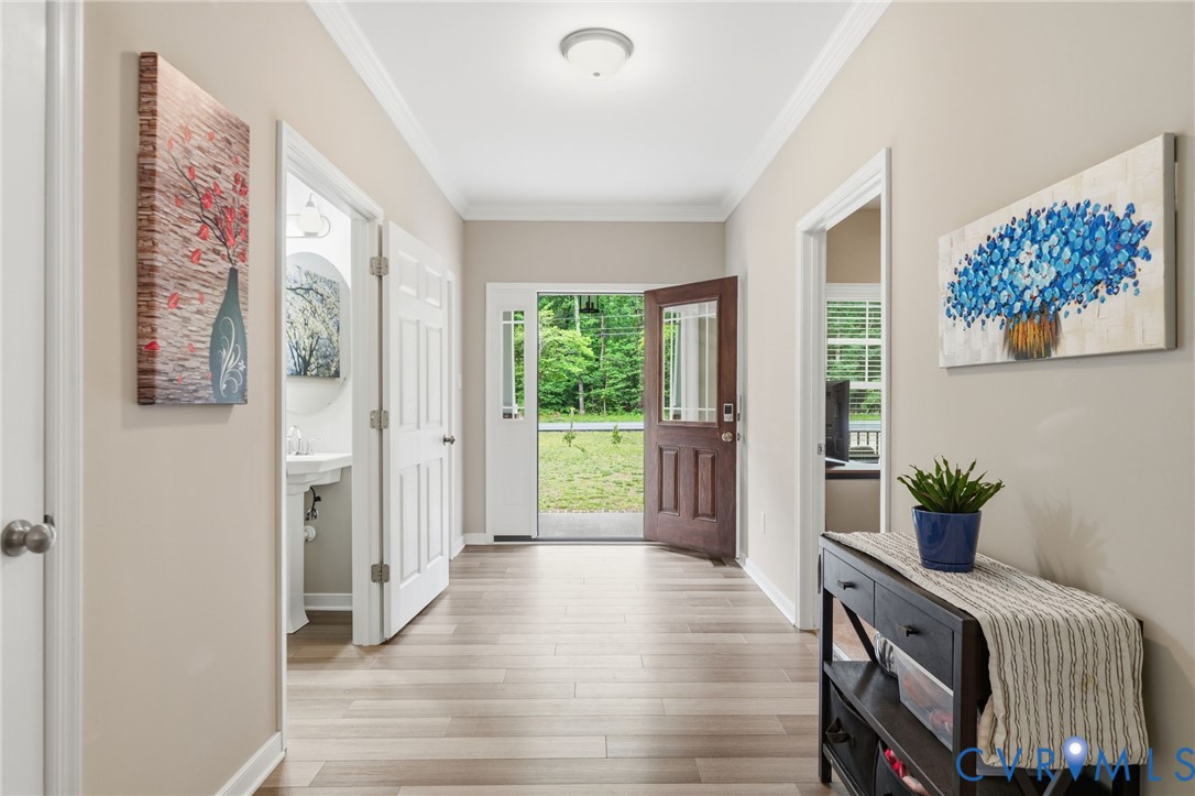 7598 Rural Point Road Mechanicsville, VA 23116 - Photo 16 of 41 a view of an entryway with wooden floor and windows