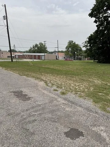 a view of yard with swimming pool and green space