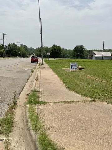 a view of a park with large trees