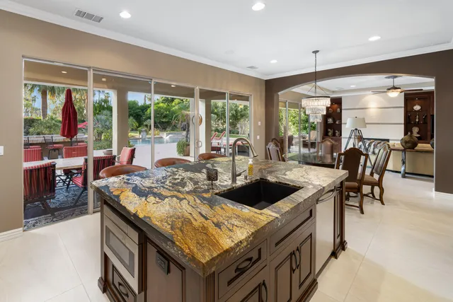 a kitchen with granite countertop sink and cabinets