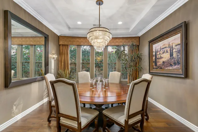 a view of a patio with couches and table and chairs and potted plants