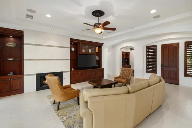 a view of a dining room with furniture a chandelier and wooden floor