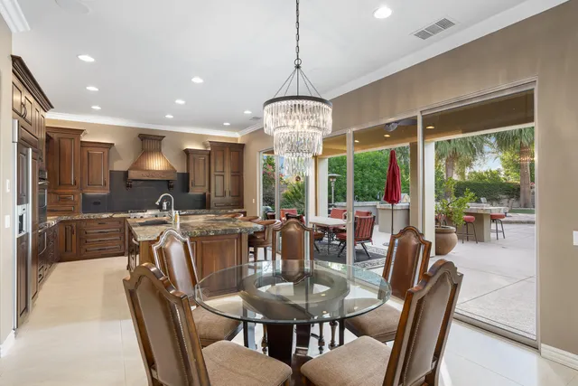 a kitchen with kitchen island granite countertop a large stove a sink and a refrigerator