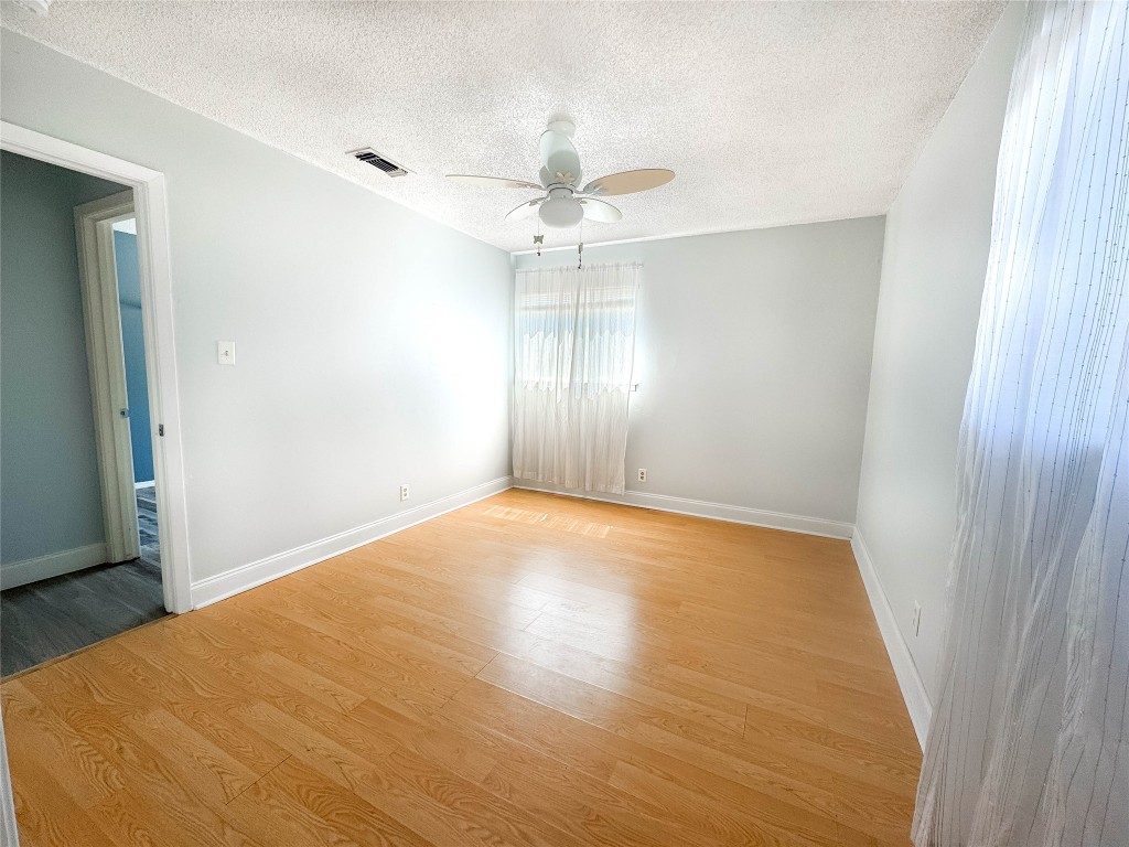 8602 Colonial Drive Austin, TX 78758 - Photo 15 of 19 wooden floor in an empty room with a window
