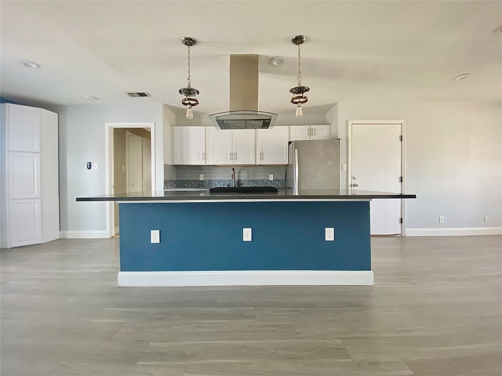 8602 Colonial Drive Austin, TX 78758 - Photo 7 of 19 a view of kitchen with stainless steel appliances granite countertop a sink and cabinets