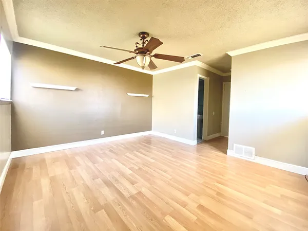 a view of a room with a ceiling fan