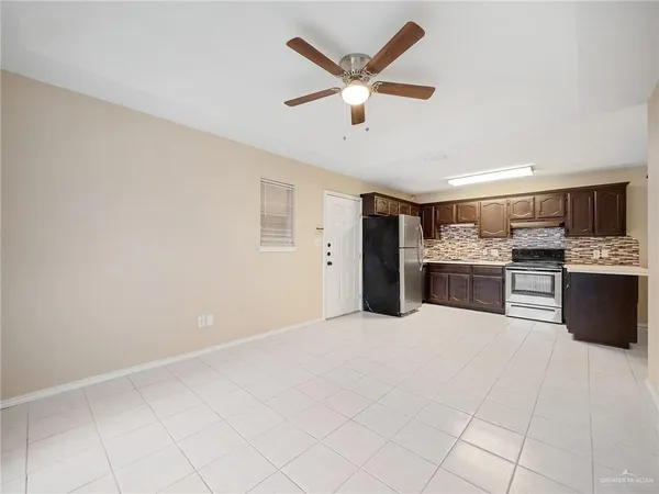 a large white kitchen with cabinets