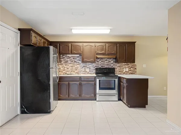 a kitchen with a refrigerator and a stove