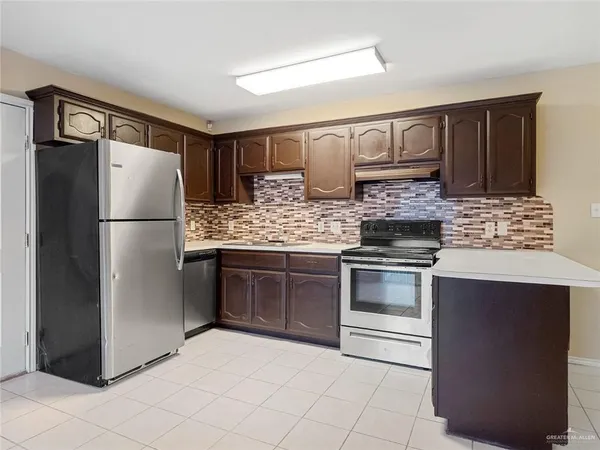 a kitchen with stainless steel appliances granite countertop a refrigerator stove and sink