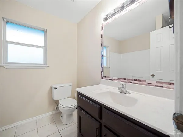 a bathroom with a sink a toilet and mirror