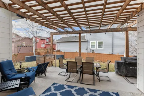 a view of a patio with table and chairs