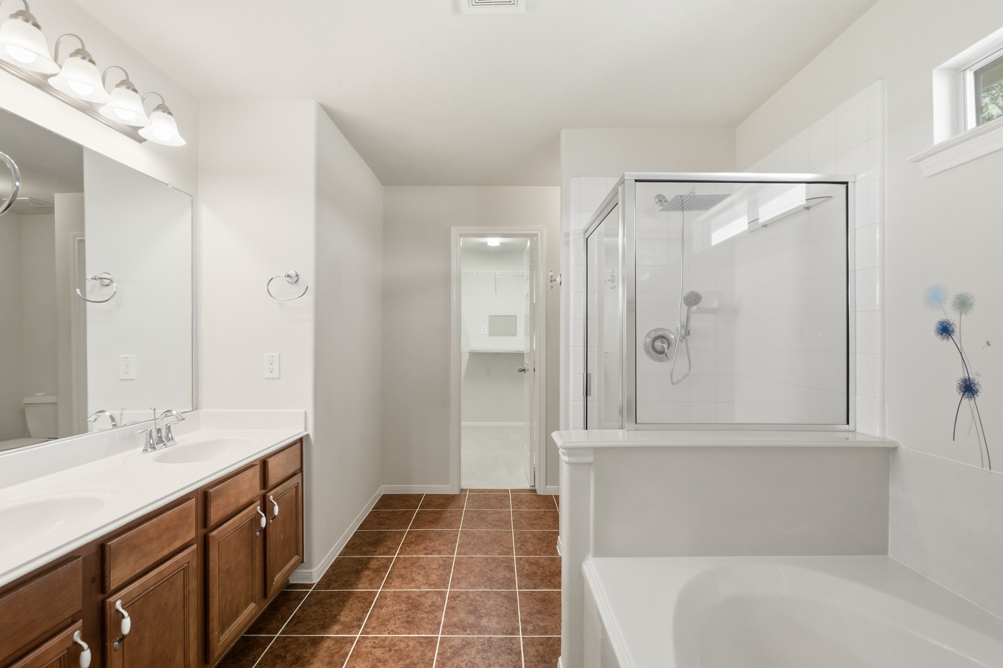 3214 Vinca Ranch Drive Katy, TX 77494 - Photo 13 of 26 Primary bath with dual sinks, soaking tub, separate glass-enclosed shower, and access to a large walk-in closet.