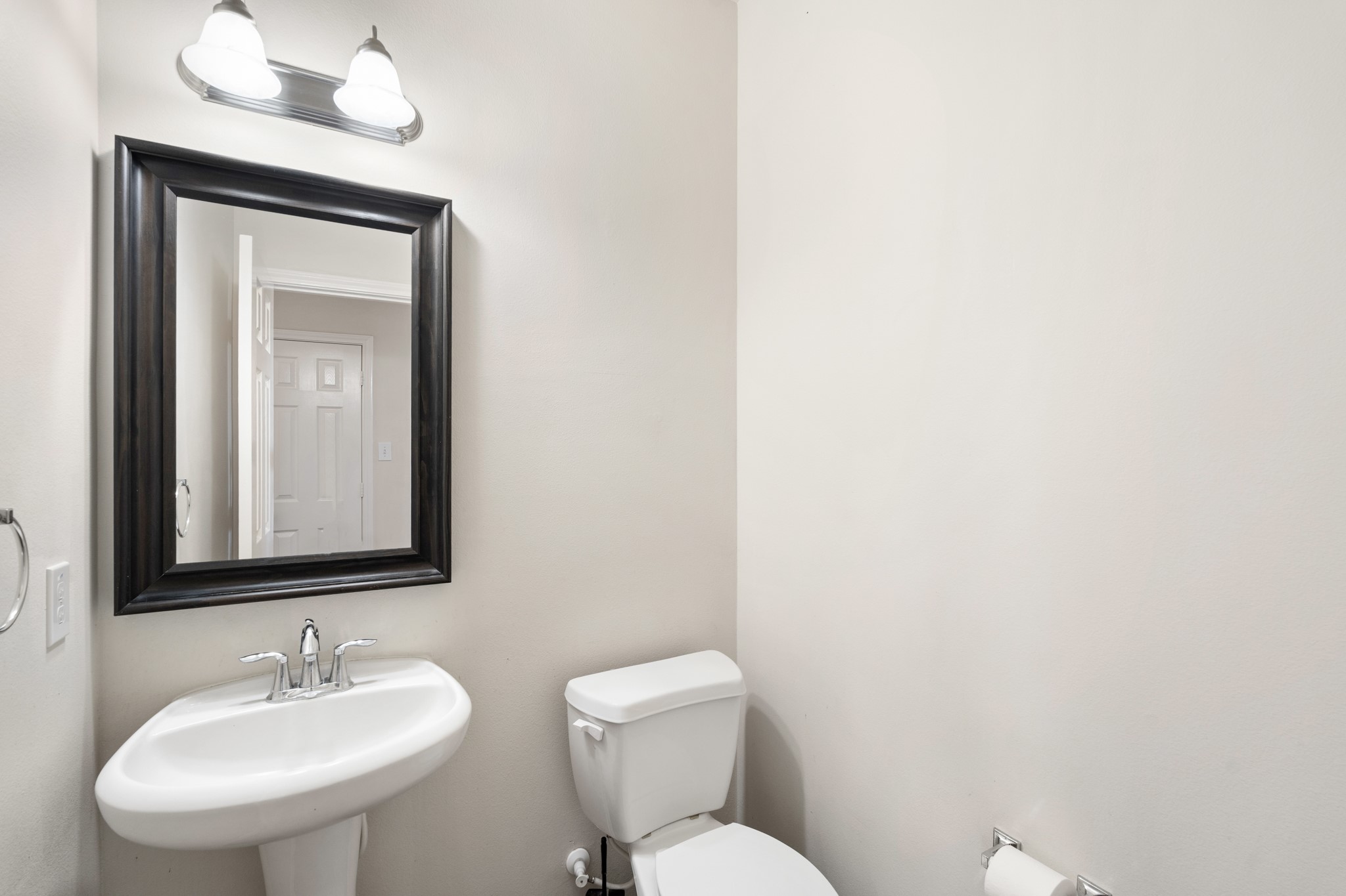 3214 Vinca Ranch Drive Katy, TX 77494 - Photo 20 of 26 Convenient half bath on the main floor featuring a pedestal sink, framed mirror, and updated lighting.
