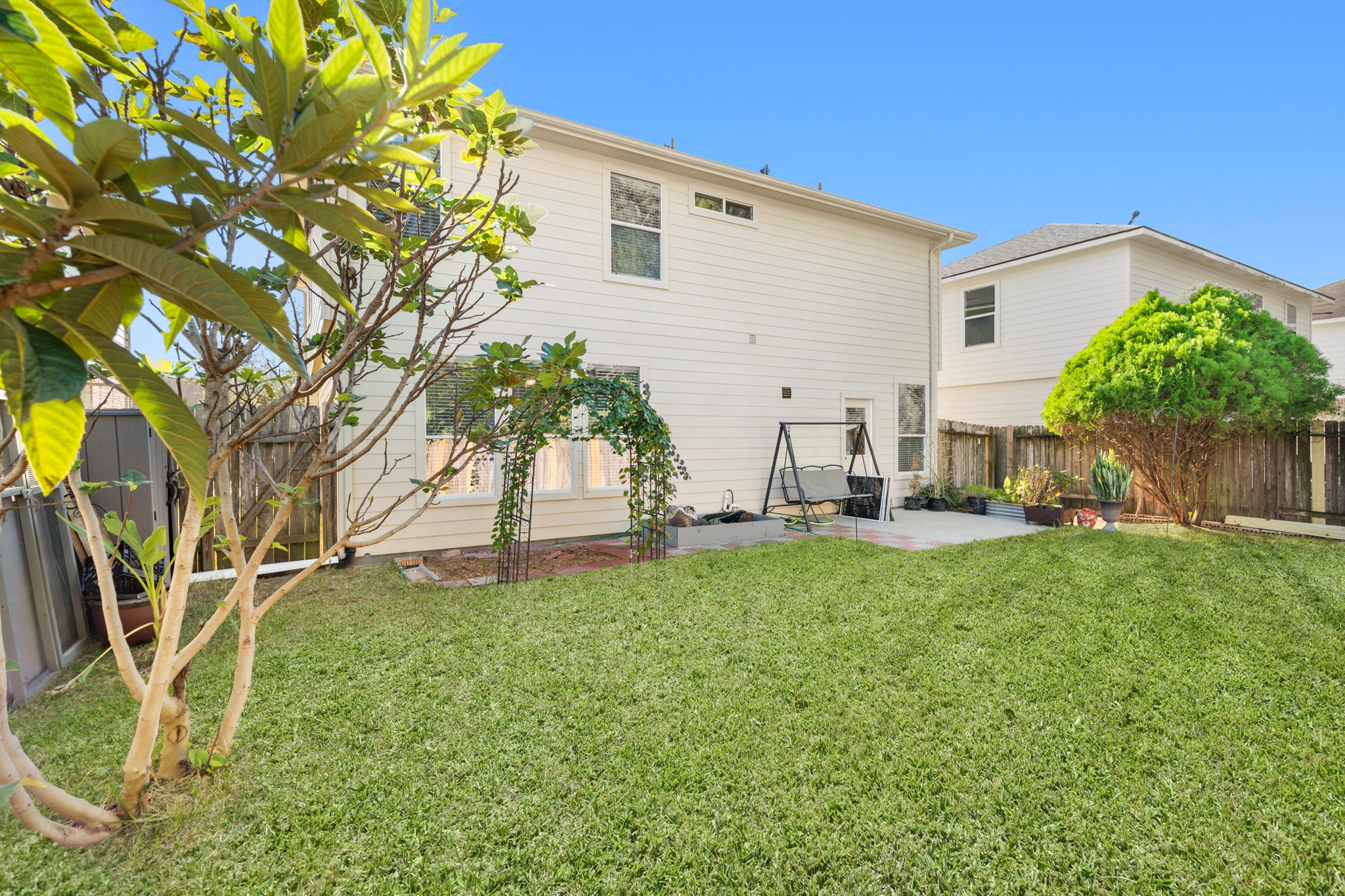 3214 Vinca Ranch Drive Katy, TX 77494 - Photo 23 of 26 Corner view of the backyard showing privacy fencing and generous yard space. Includes a concrete patio area—perfect for seating or play.
