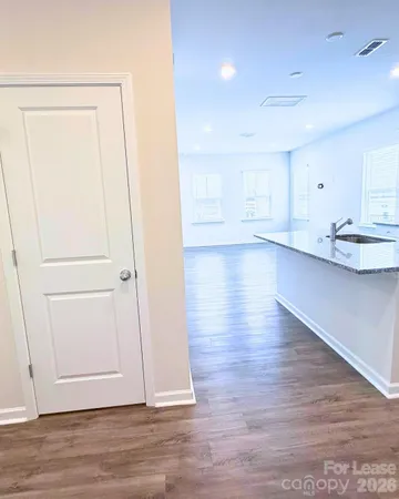 an empty room with wooden floor and closet
