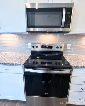 a stove top oven sitting inside of a kitchen