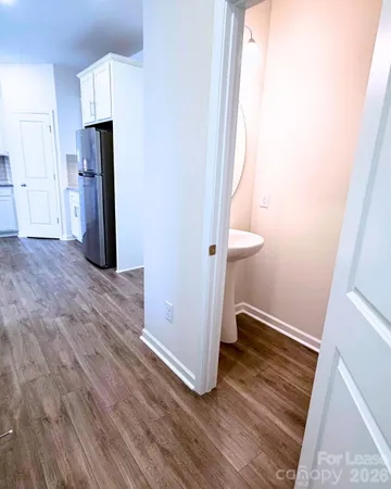 a view of hallway with wooden floor and staircase