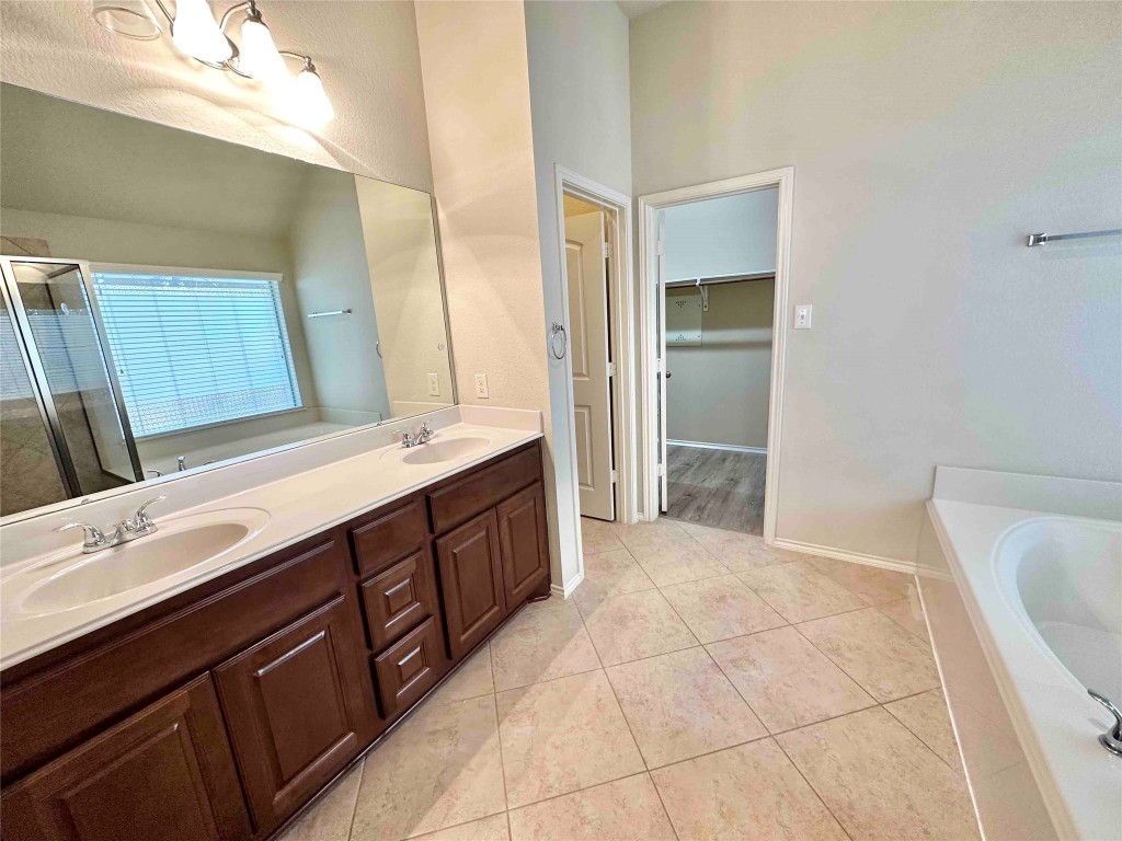 1801 Tall Chief Leander, TX 78641 - Photo 16 of 23 a spacious bathroom with a tub sink and mirror