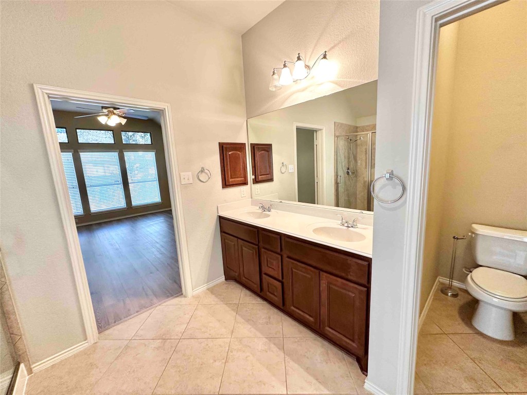1801 Tall Chief Leander, TX 78641 - Photo 17 of 23 a spacious bathroom with a double vanity sink toilet and mirror