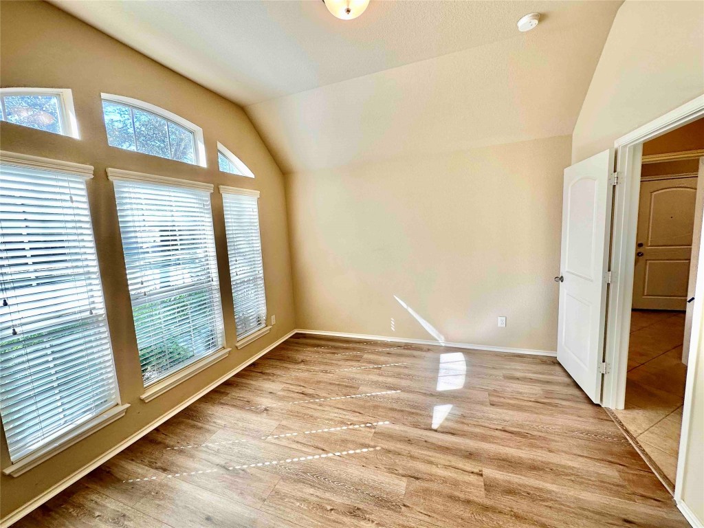 1801 Tall Chief Leander, TX 78641 - Photo 3 of 23 a view of an empty room with wooden floor and a window